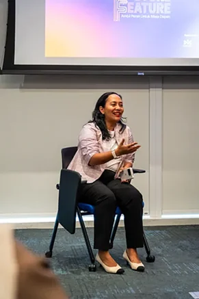 Muriel Makarim seated during the session