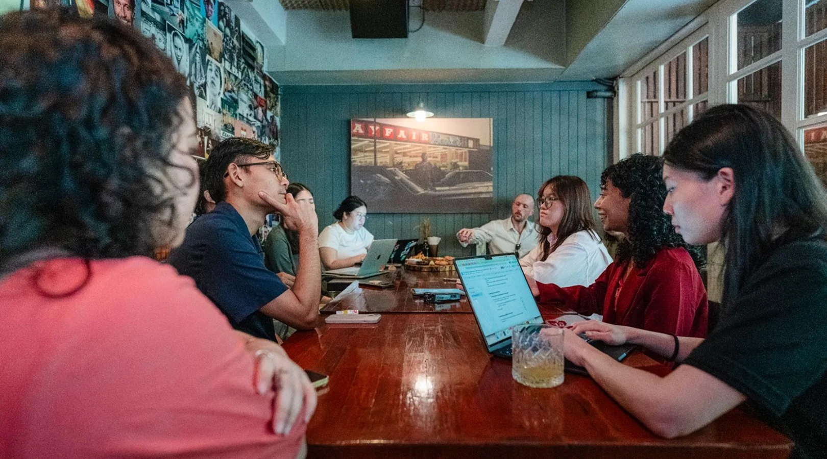 Fellows in a facilitated group reflection around a table