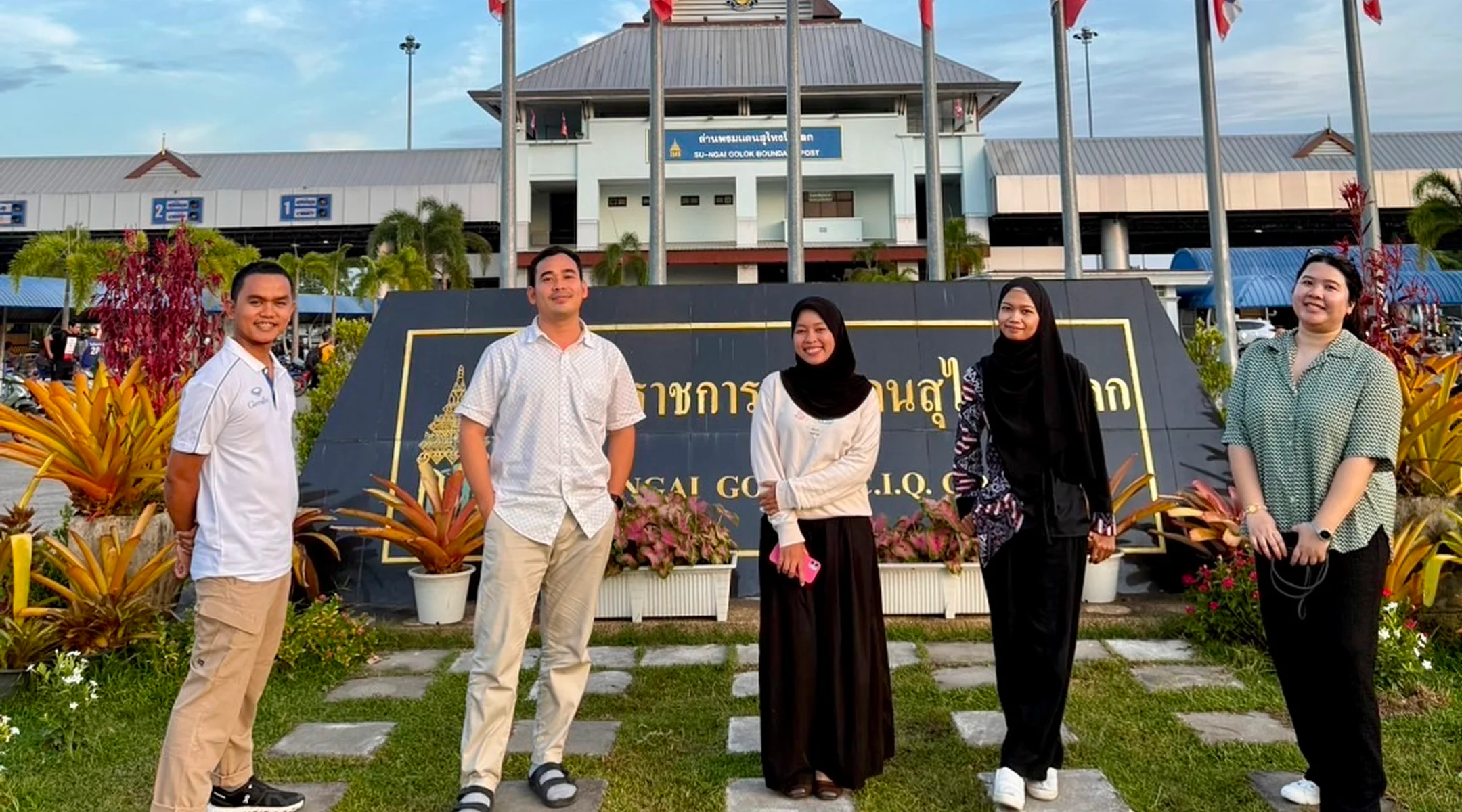 The author and the Luukrieang team standing in front of a government building in Thailand’s Southern Border Provinces