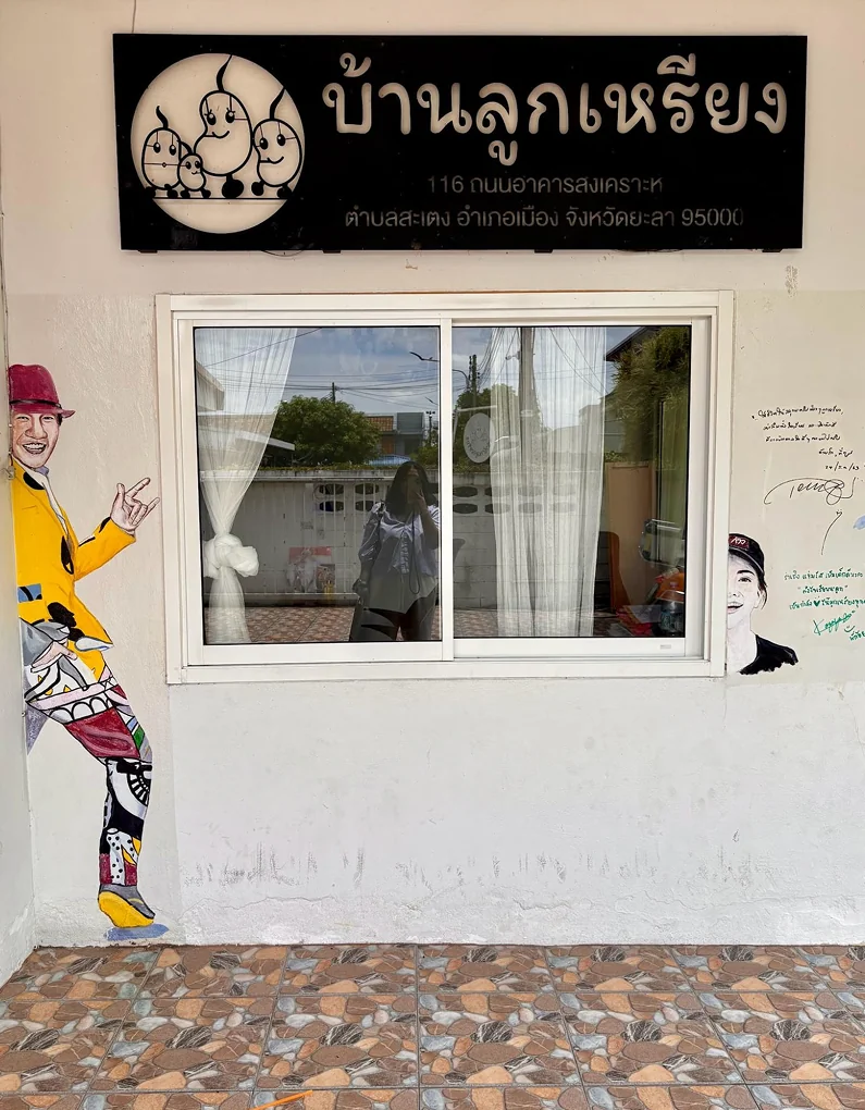 A painted mural figure beside a window on the Luukrieang office wall