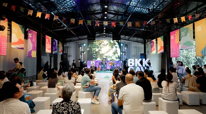 An indoor event hall with an audience and stage