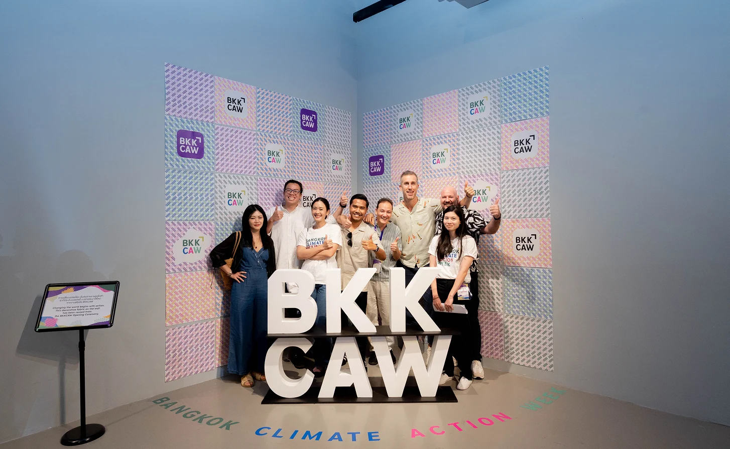 Participants behind the BKKCAW letters at the closing