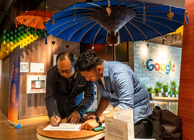 A participant signing at the Future Feature exhibit